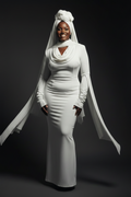 Beautiful Black plus-sized woman wearing the VELMORI Ivory Drape Dress with matching white headwrap